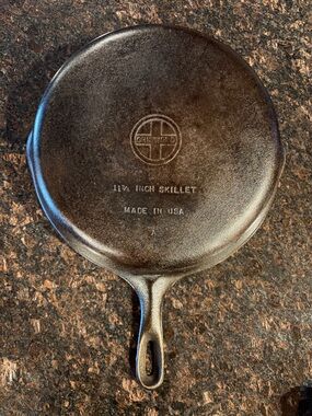 Griswold Number 10 Cast iron skillet. 
Black skillet with small block logo